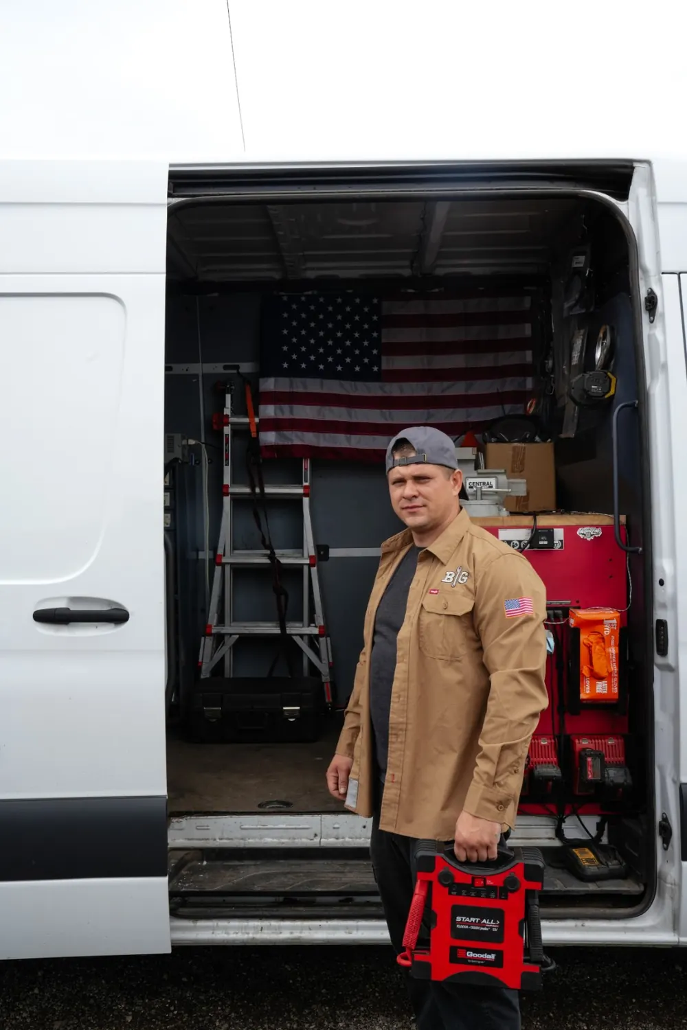 BIG mechanic beside the mobile repair van